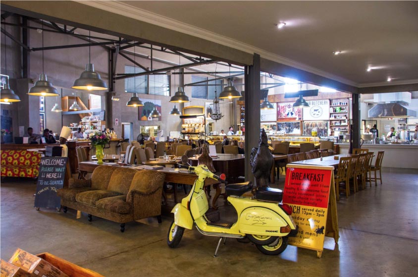 Image of interior with an old vespa and view of seating area